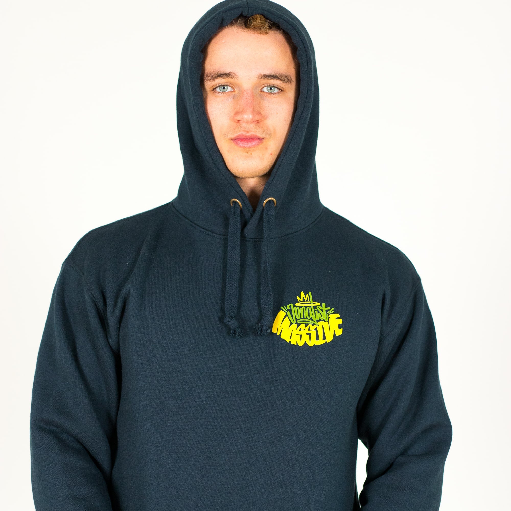 Person wearing a navy Junglist Massive hoodie with a yellow logo on a white background