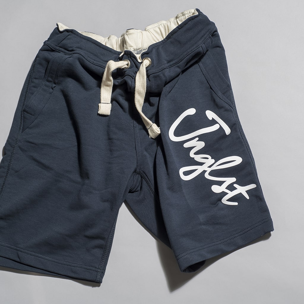 Navy Shorts with White Jnglst Clothing logo wrapped around leg