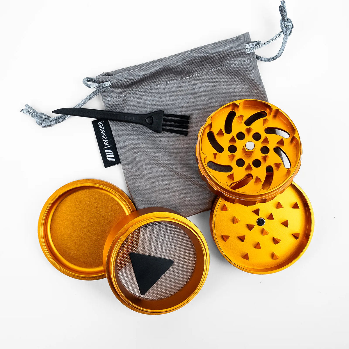 An orange metal herb grinder set with a gray drawstring bag, black plastic fork, and black mesh screen, arranged on a white background.