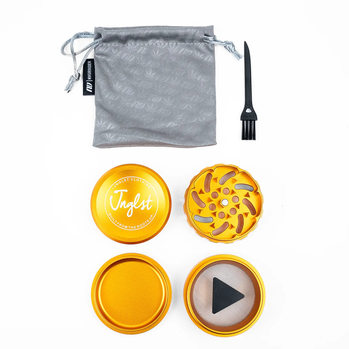 A metal herb grinder set with a gray drawstring pouch, black cleaning brush, and four gold-toned metal components on a white background. The top piece features the brand name 'Taglst' printed in white.