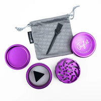 Purple metal herb grinder set with a gray drawstring pouch, black metal tool, and purple lid on a white background.