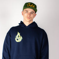 Person wearing a navy Born Outta Fire Collab hoodie with a logo and a green cap with text on a plain background