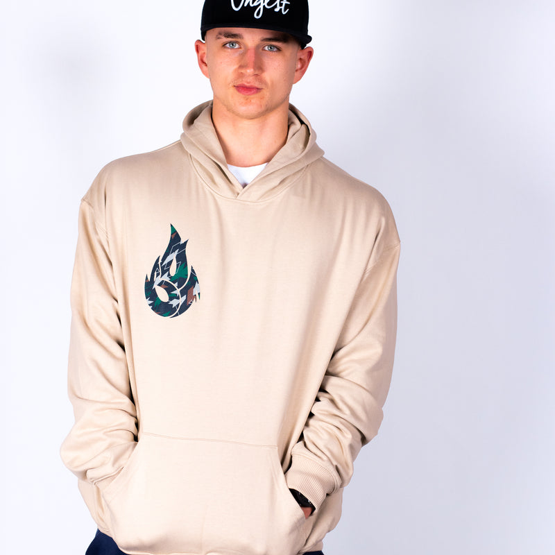 Person wearing a beige hoodie with a logo on a white background