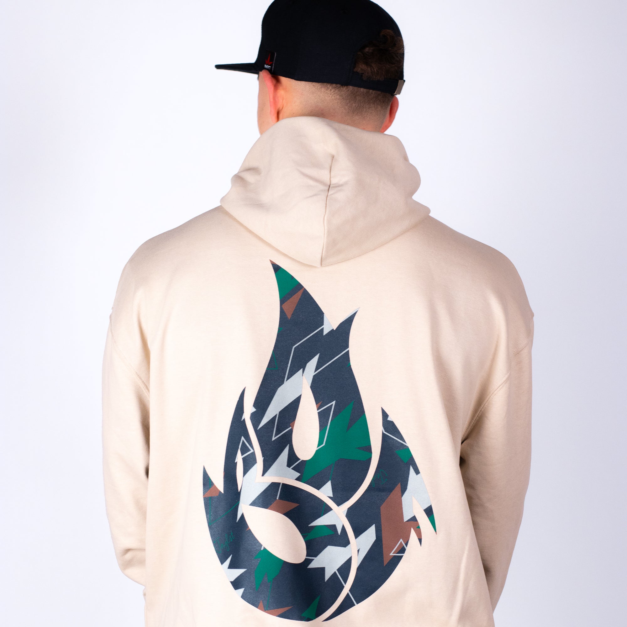 Person wearing a beige hoodie with a colorful logo on the back against a white background