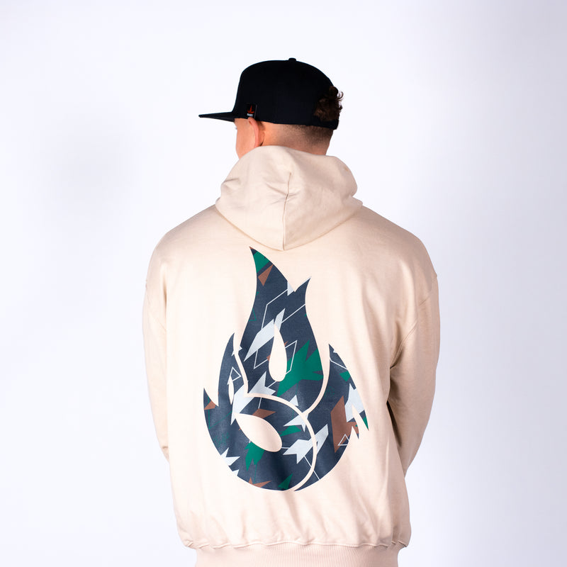 Person wearing a beige Junglist hoodie with a large logo on the back, standing against a white background