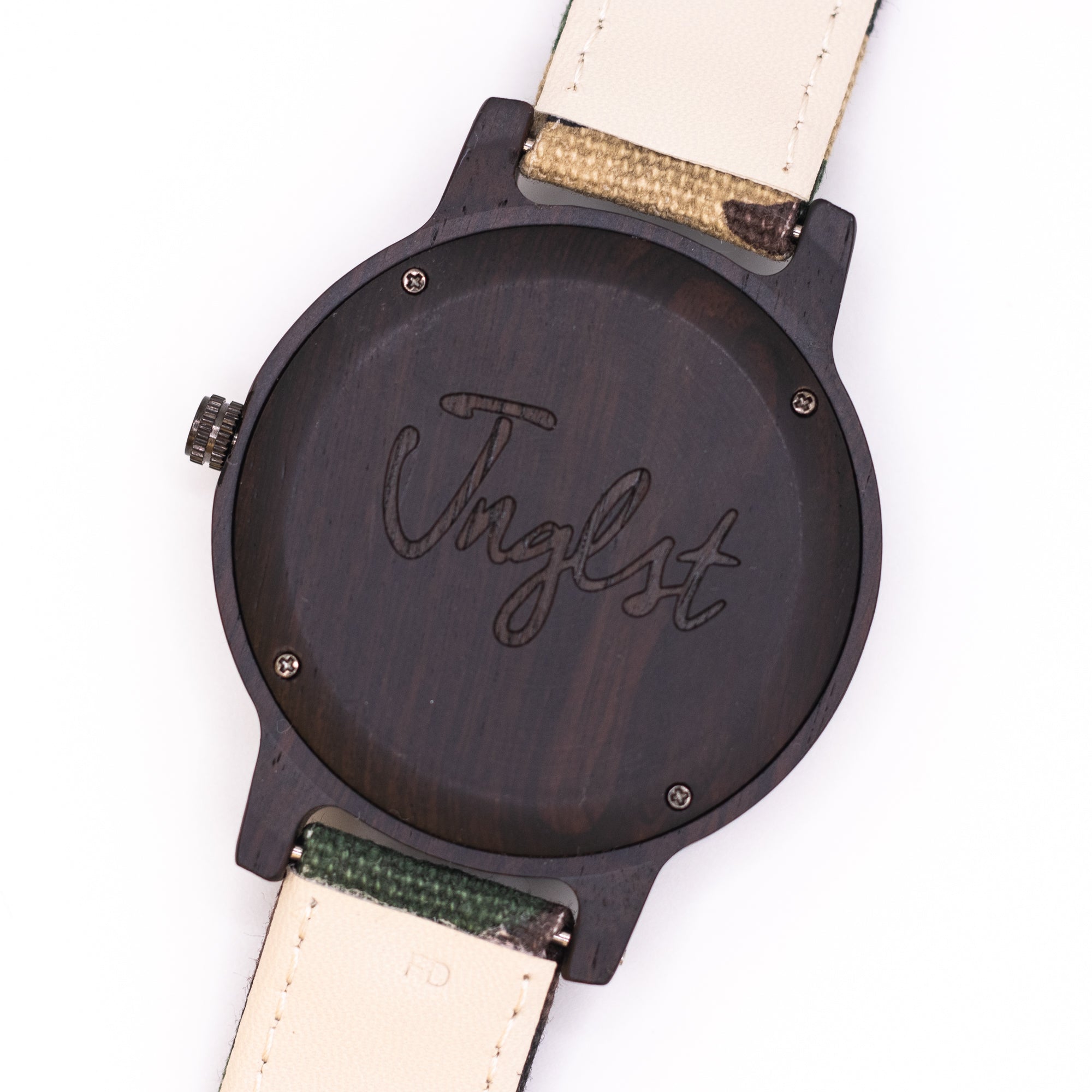 Wooden watch with 'Jnglst' engraved on a white background