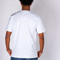 Person wearing a plain white t-shirt against a light gray background