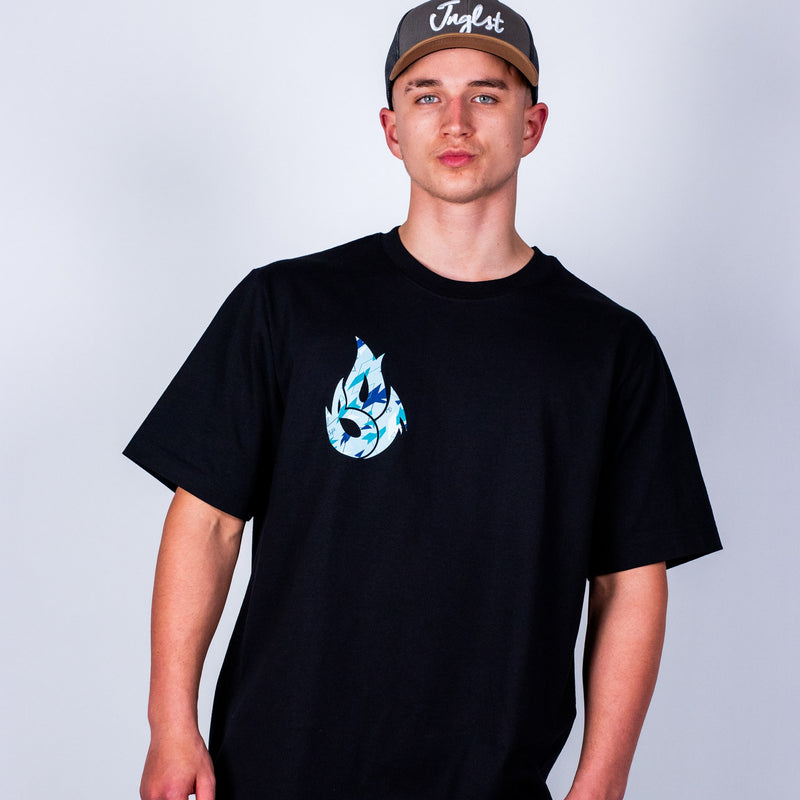 Person wearing a black t-shirt with a blue graphic design on a plain background