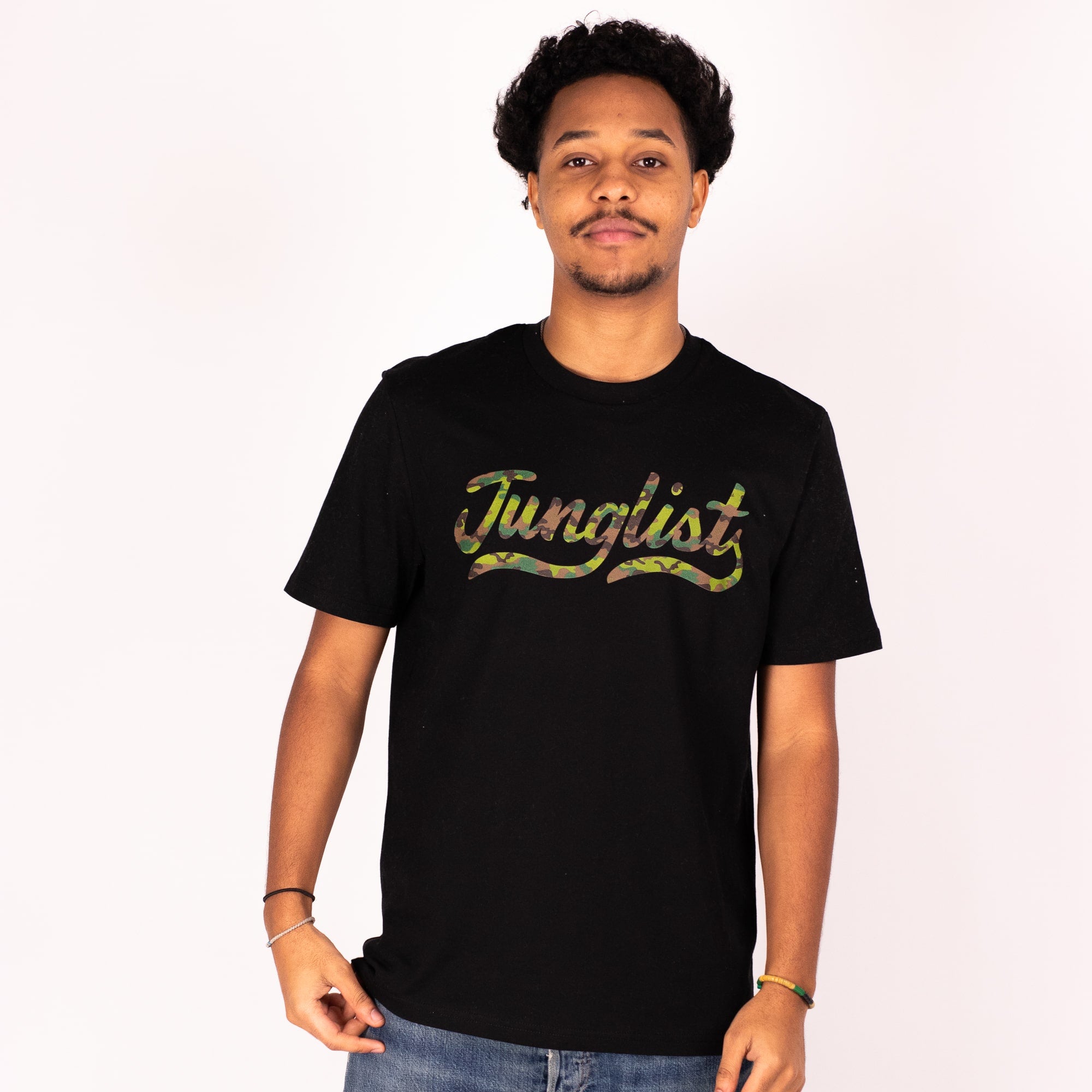 Person wearing a black t-shirt with 'Junglist' text on a white background