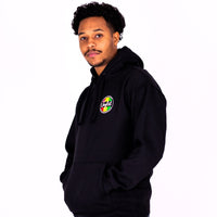 Person wearing a black hoodie with a colorful logo on a white background