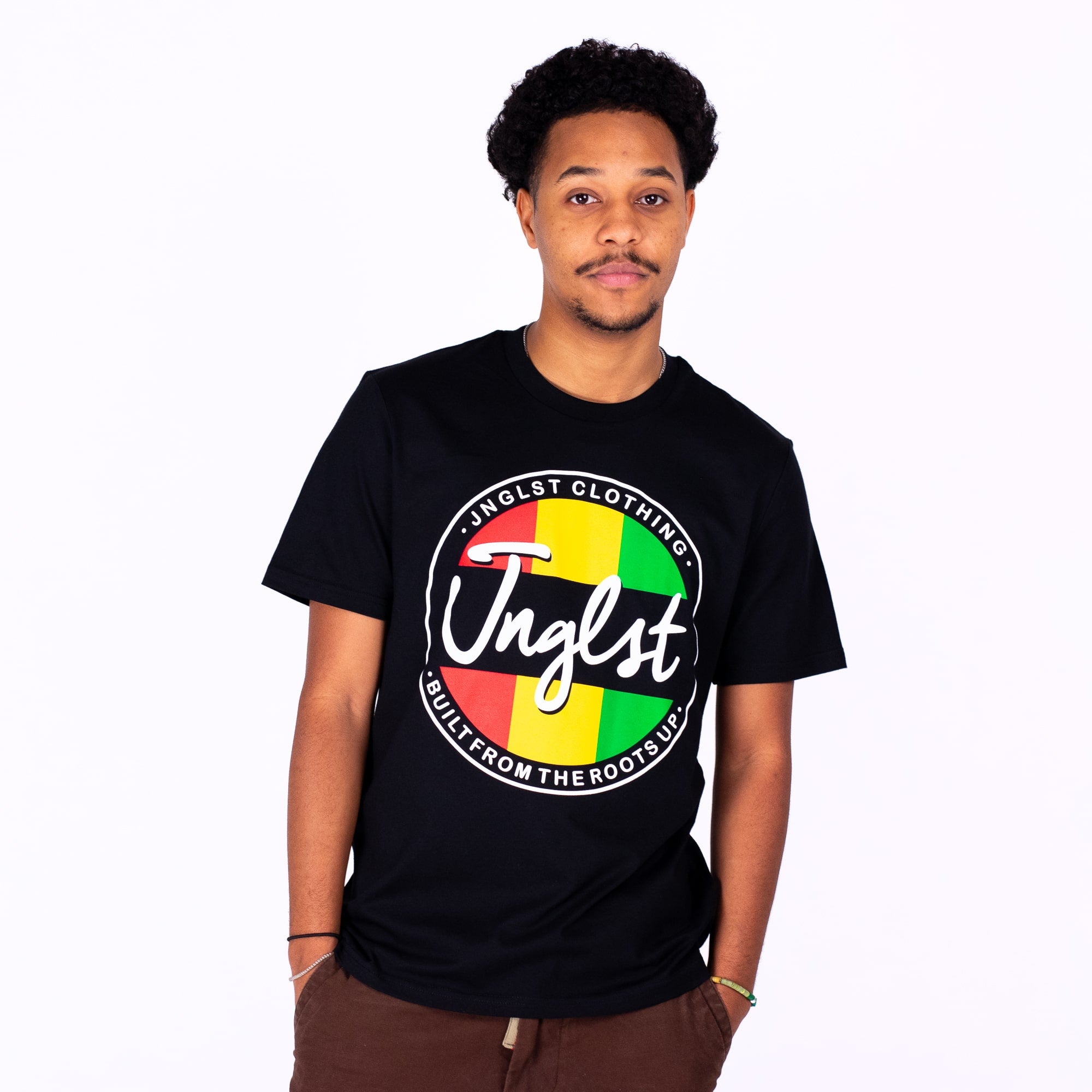 Person wearing a black t-shirt with colorful Junglist branding on a white background