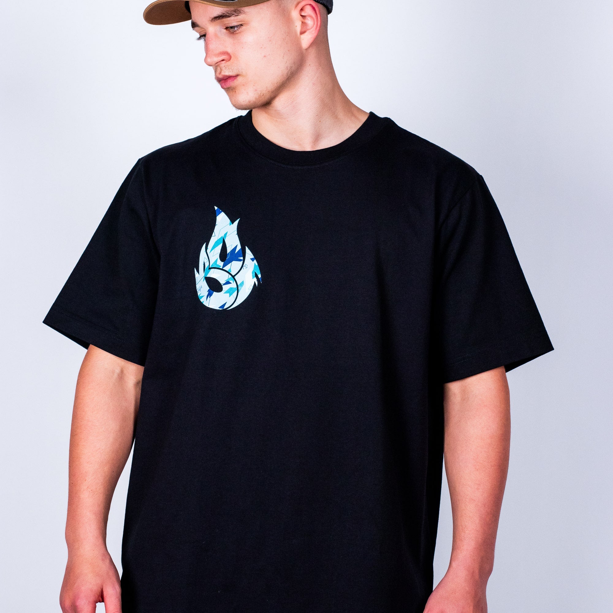Person wearing a black Junglist t-shirt with a blue and white graphic design on a plain background