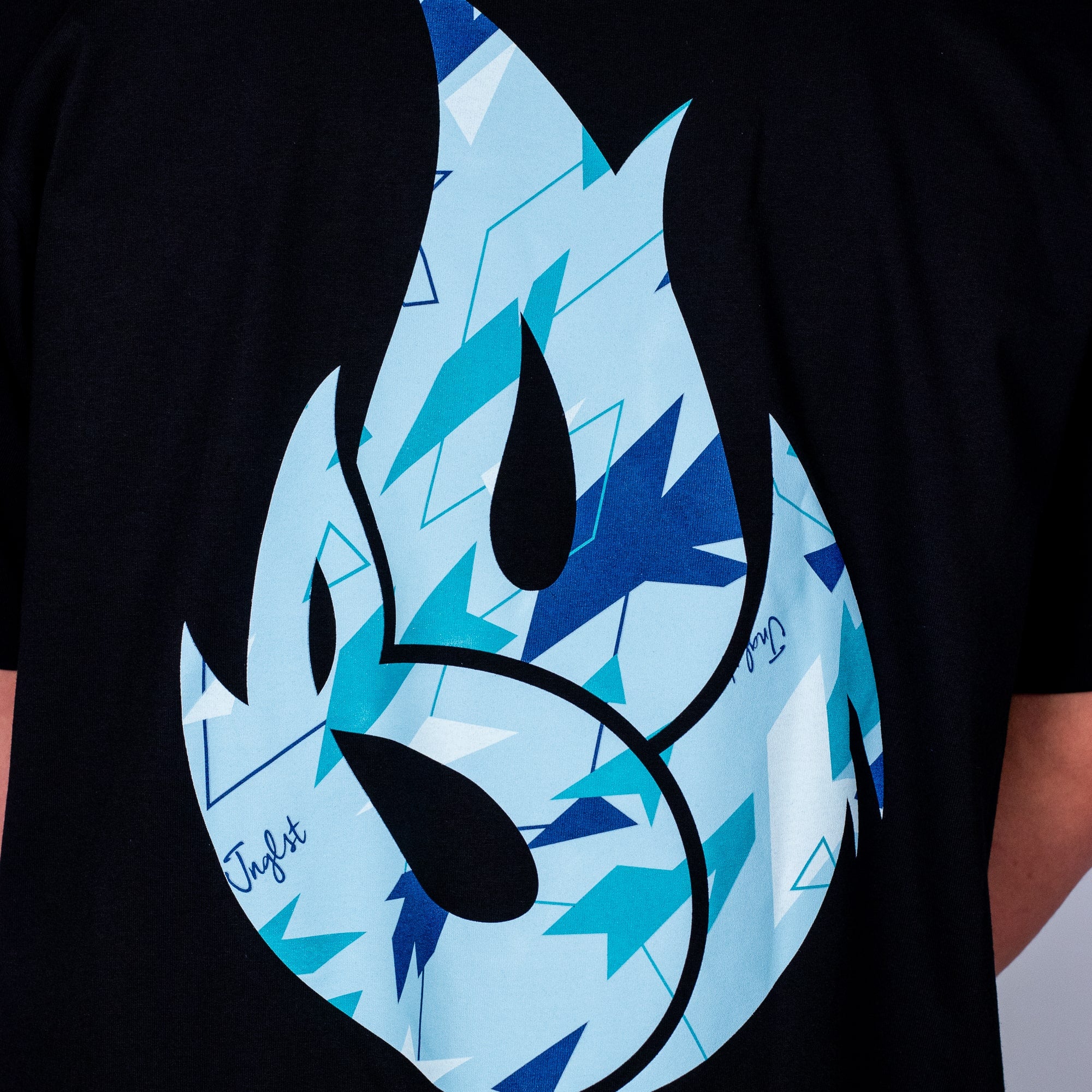 Black t-shirt with a blue and black Born Outta Fire flame design on a plain background