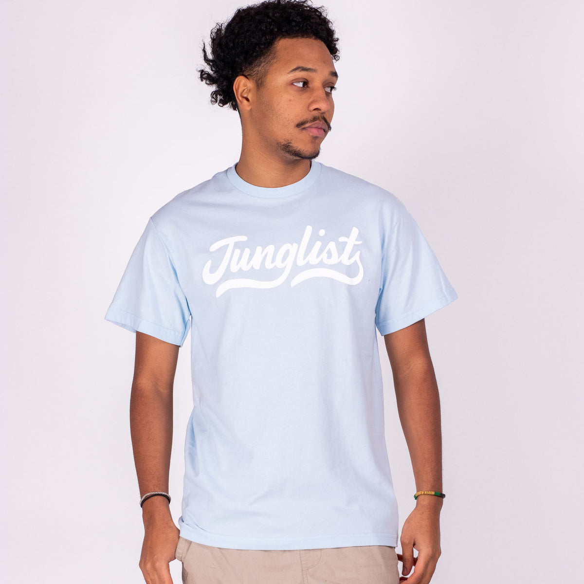 Man wearing a light blue t-shirt with 'Junglist' text on a white background