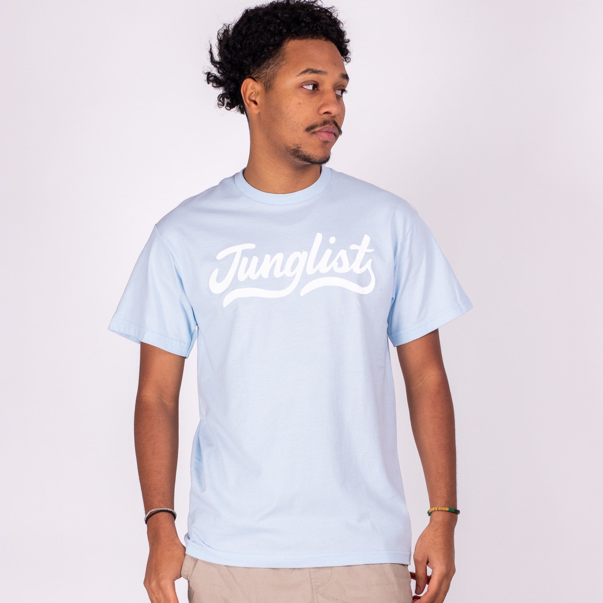 Man wearing a light blue t-shirt with 'Junglist' text on a white background
