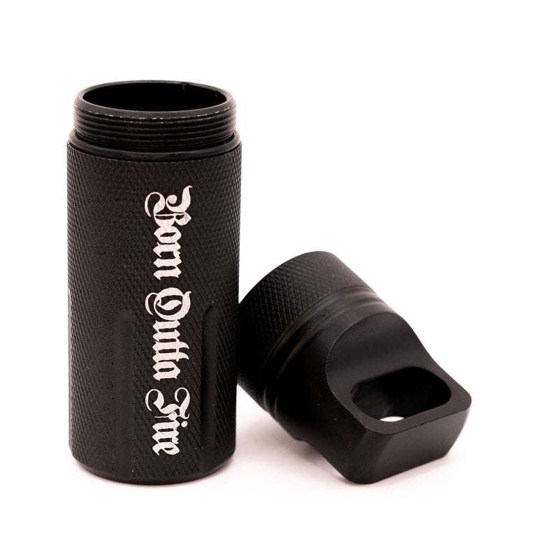 Black metal tube with 'Born Outta Fire' engraving on a white background