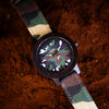 Watch with camouflage strap and face on a textured brown background