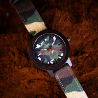 Watch with camouflage strap and face on a textured brown background