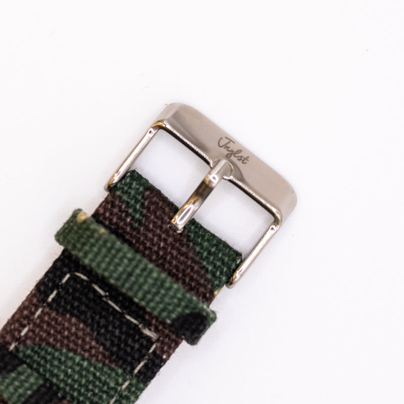 Camouflage watch strap with silver buckle and Jnglst logo on a white background