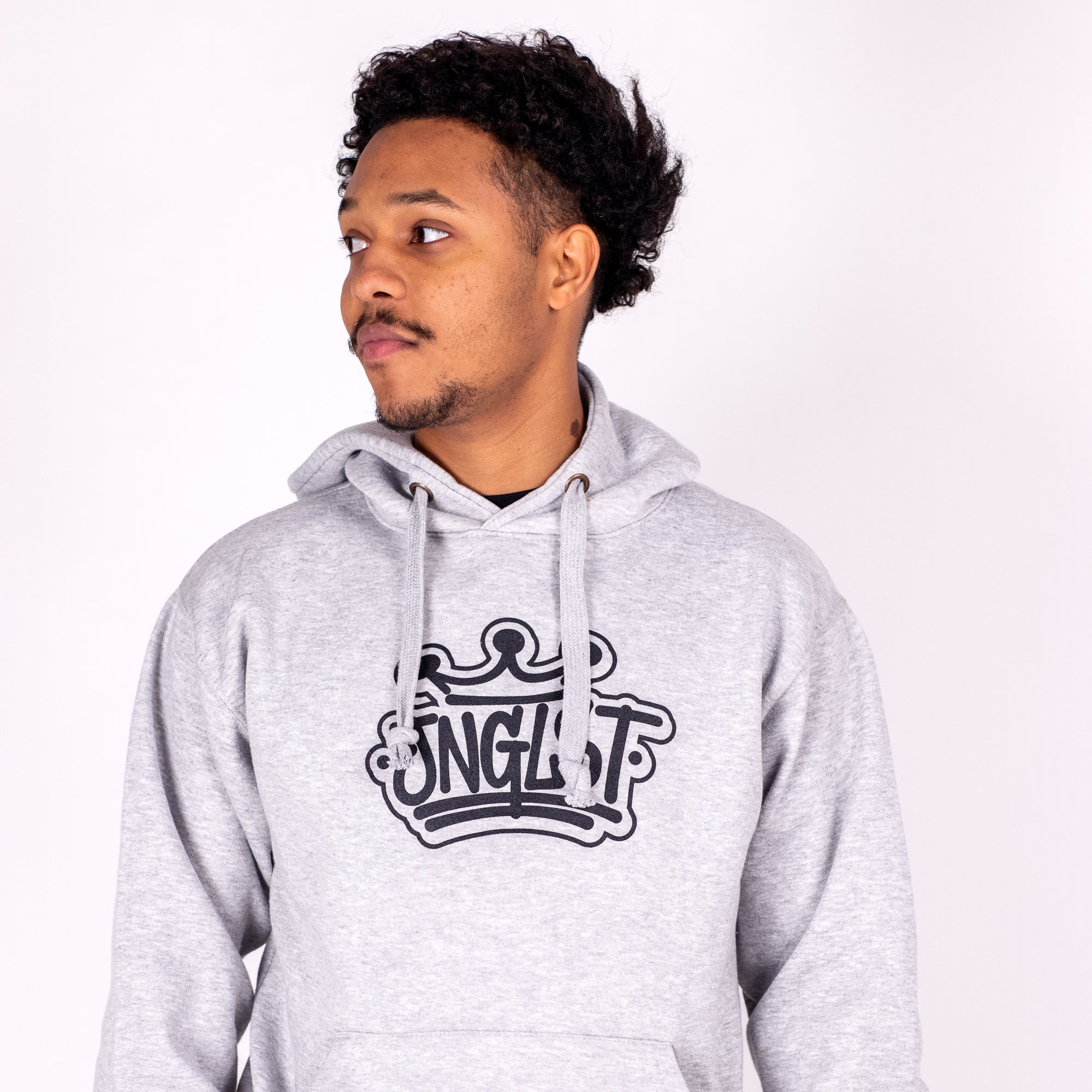 Person wearing a gray hoodie with a logo on a white background