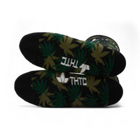 Black socks with green leaf pattern and 'THC' text on a white background