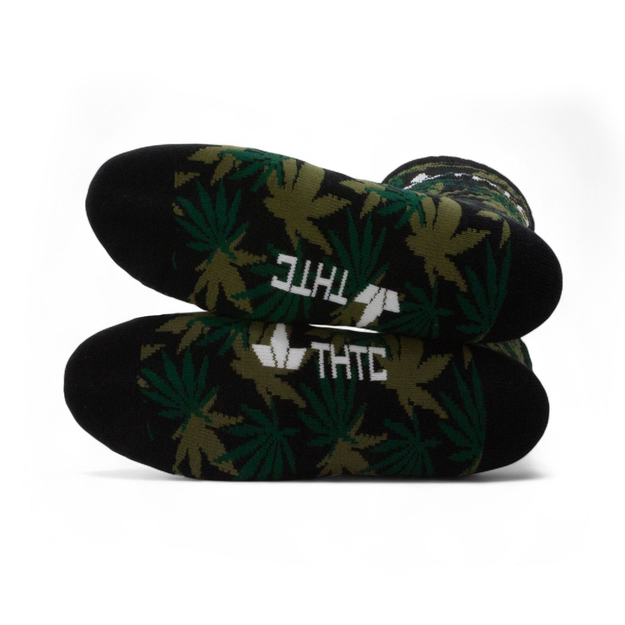 Black socks with green leaf pattern and 'THC' text on a white background