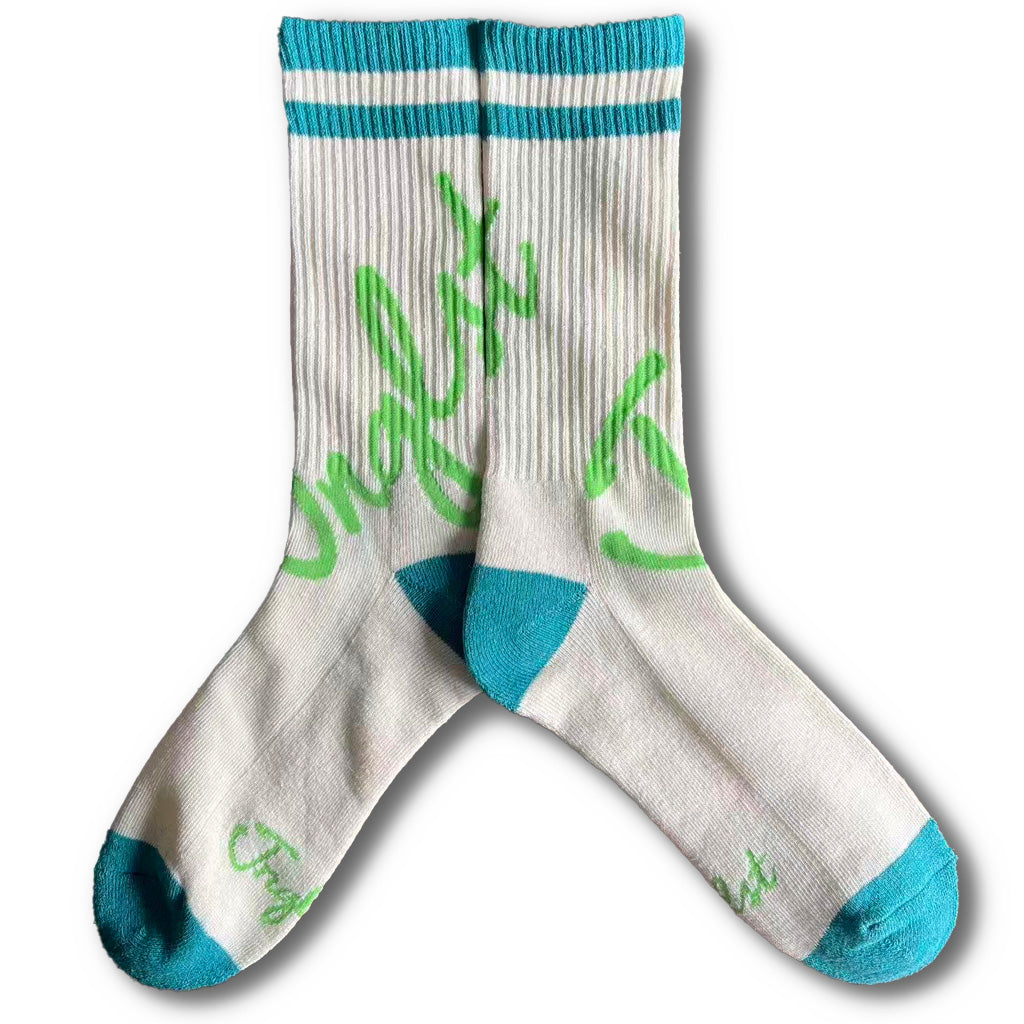 Pair of socks with green text and blue Junglist accents on a white background