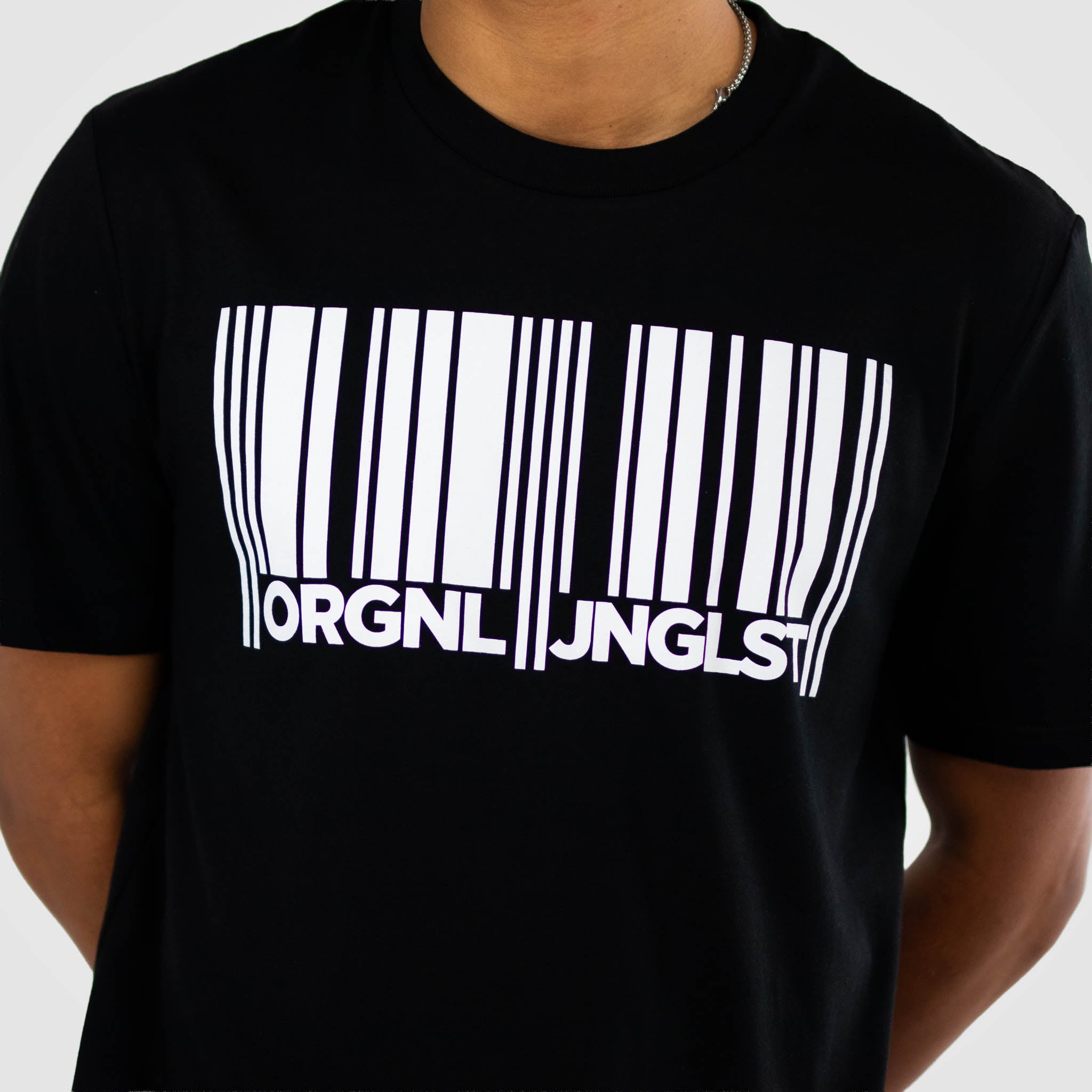 Black t-shirt with a white Junglist barcode design and text on a plain background