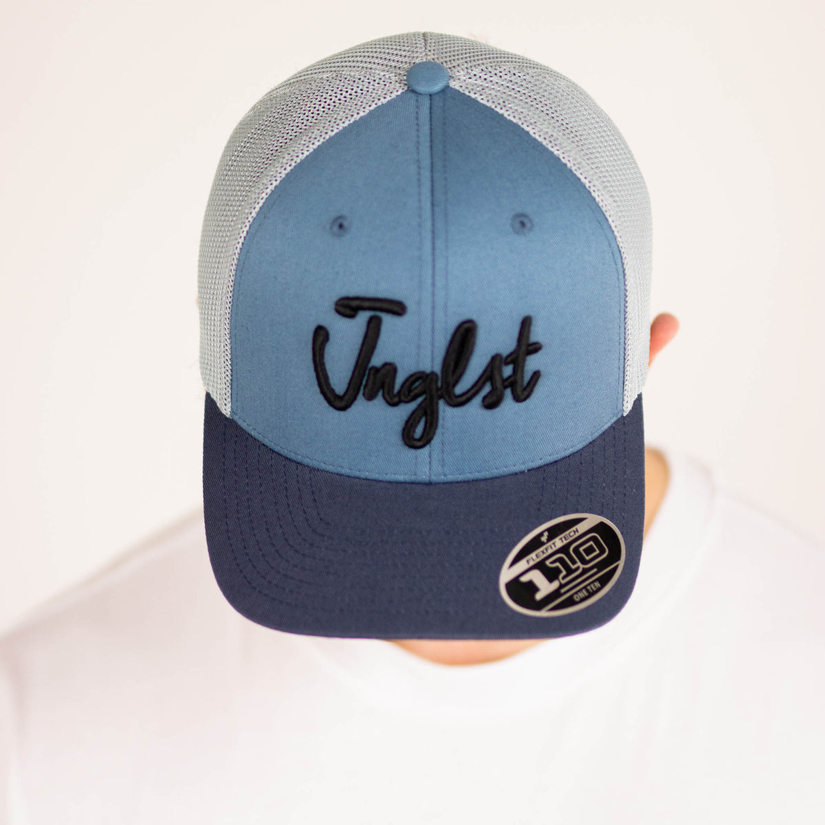 Jnglst Trucker Cap Blue worn by model in studio