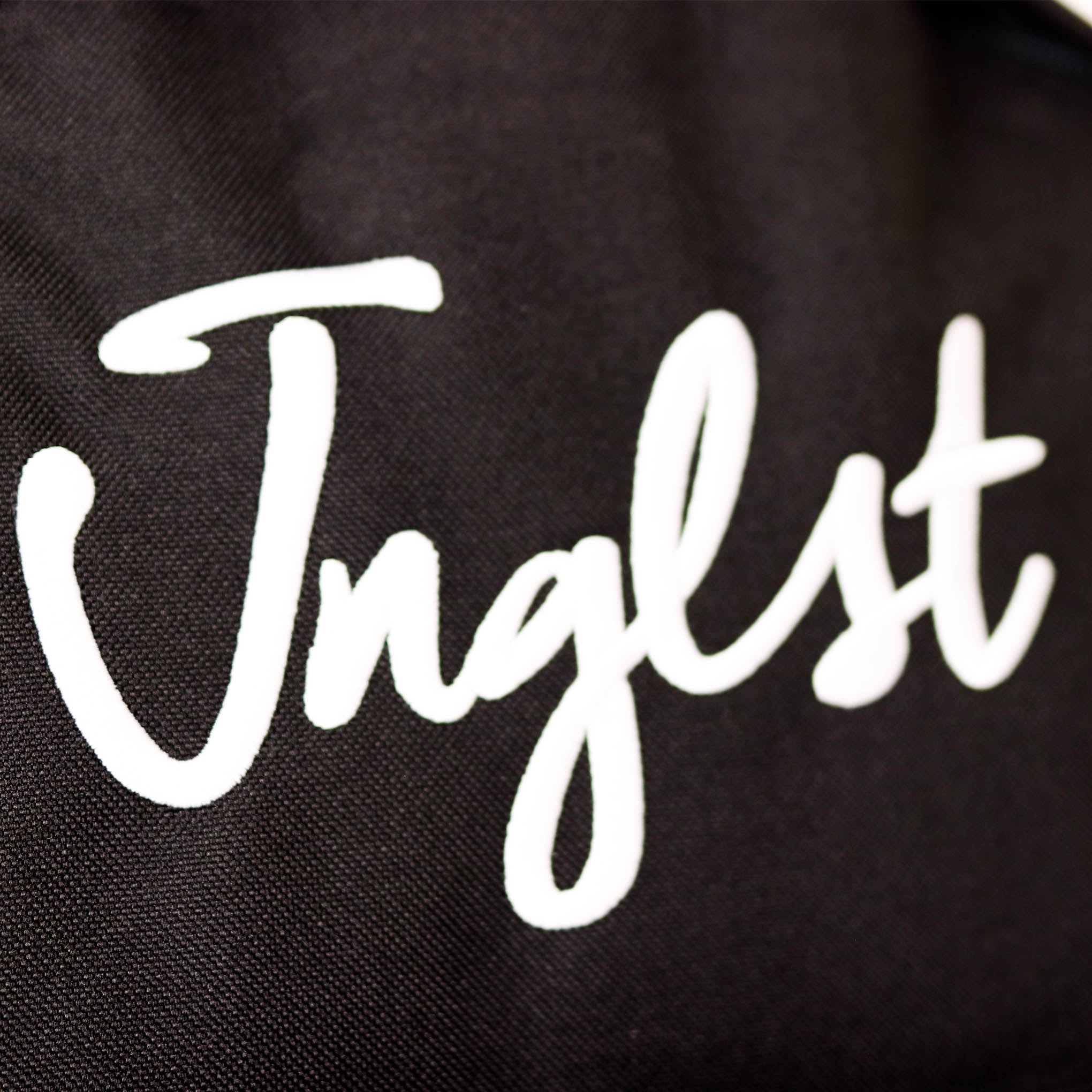 Jnglst logo on Backpack
