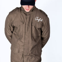 Person wearing a brown jacket with 'Jungle' branding on a white background