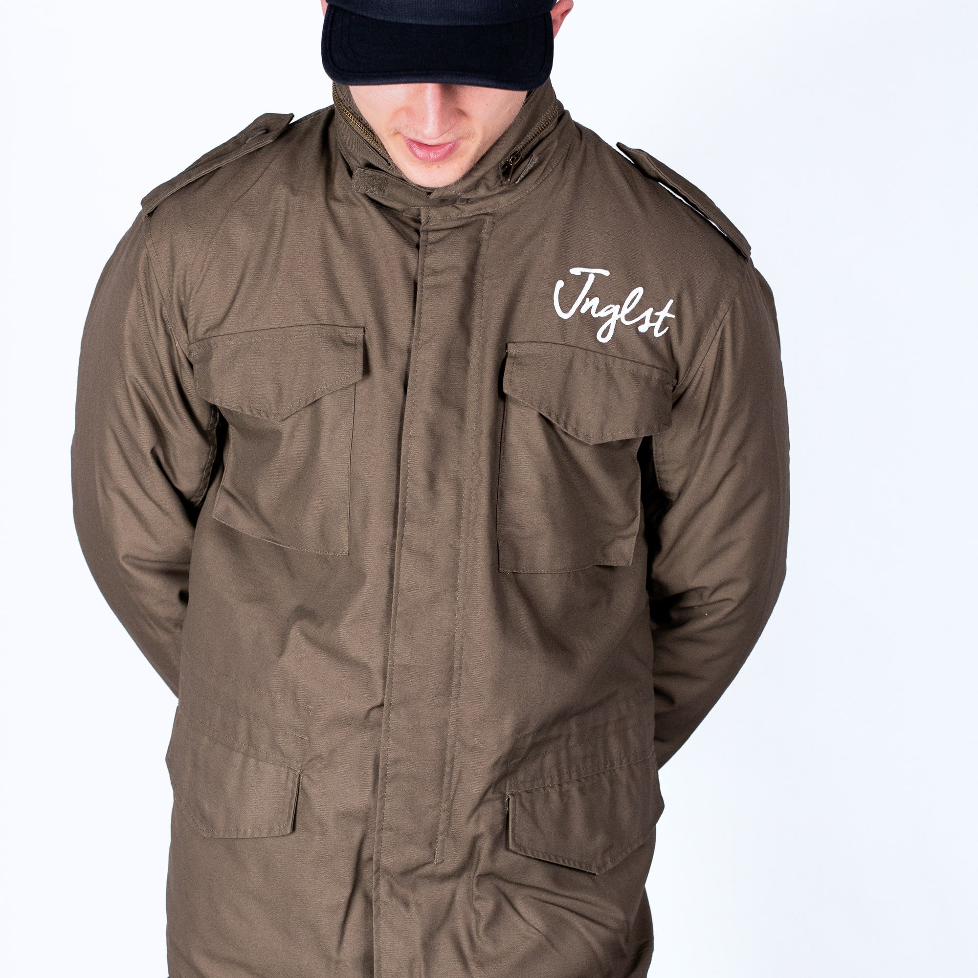 Person wearing a brown jacket with 'Jungle' branding on a white background
