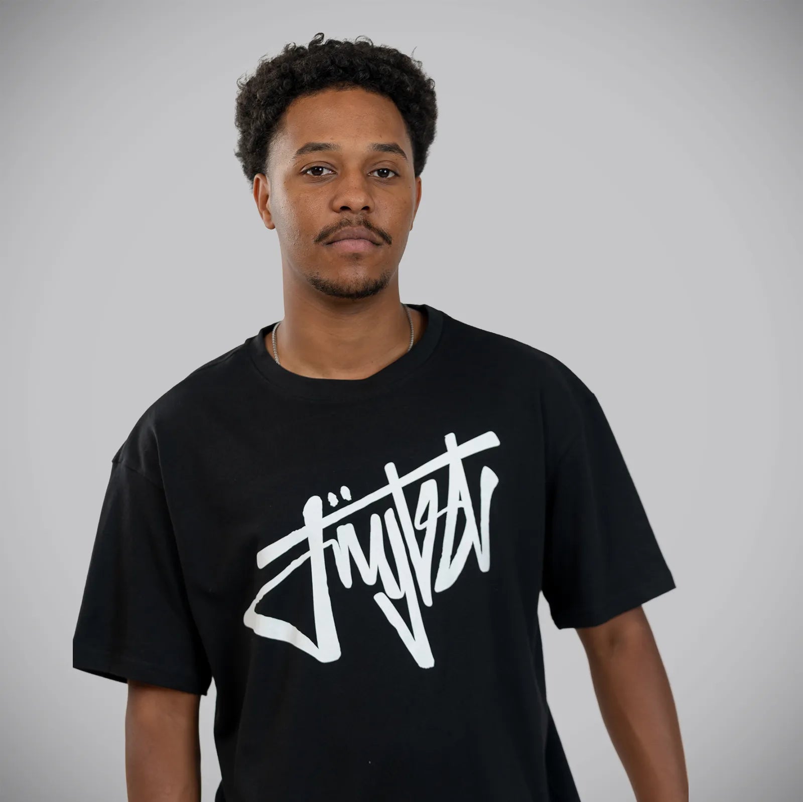 Jnglst Clothing model wearing black front script t shirt