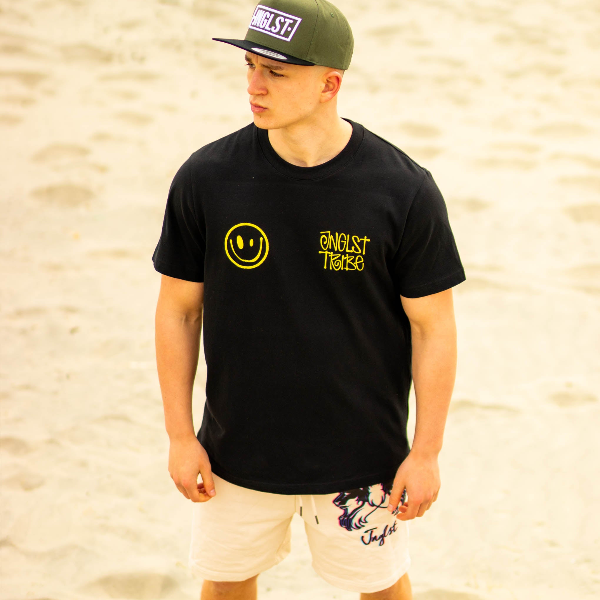 Jnglst Tribe Rewired Smiley T-Shirt worn in sand dunes