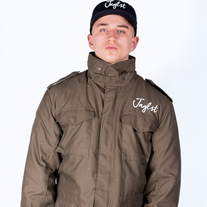 Person wearing a brown jacket and black cap with 'Jinglist' branding on a white background