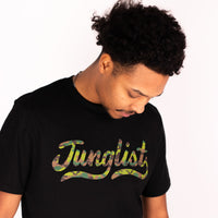 Person wearing a black t-shirt with 'Junglist' printed in colorful letters on a white background