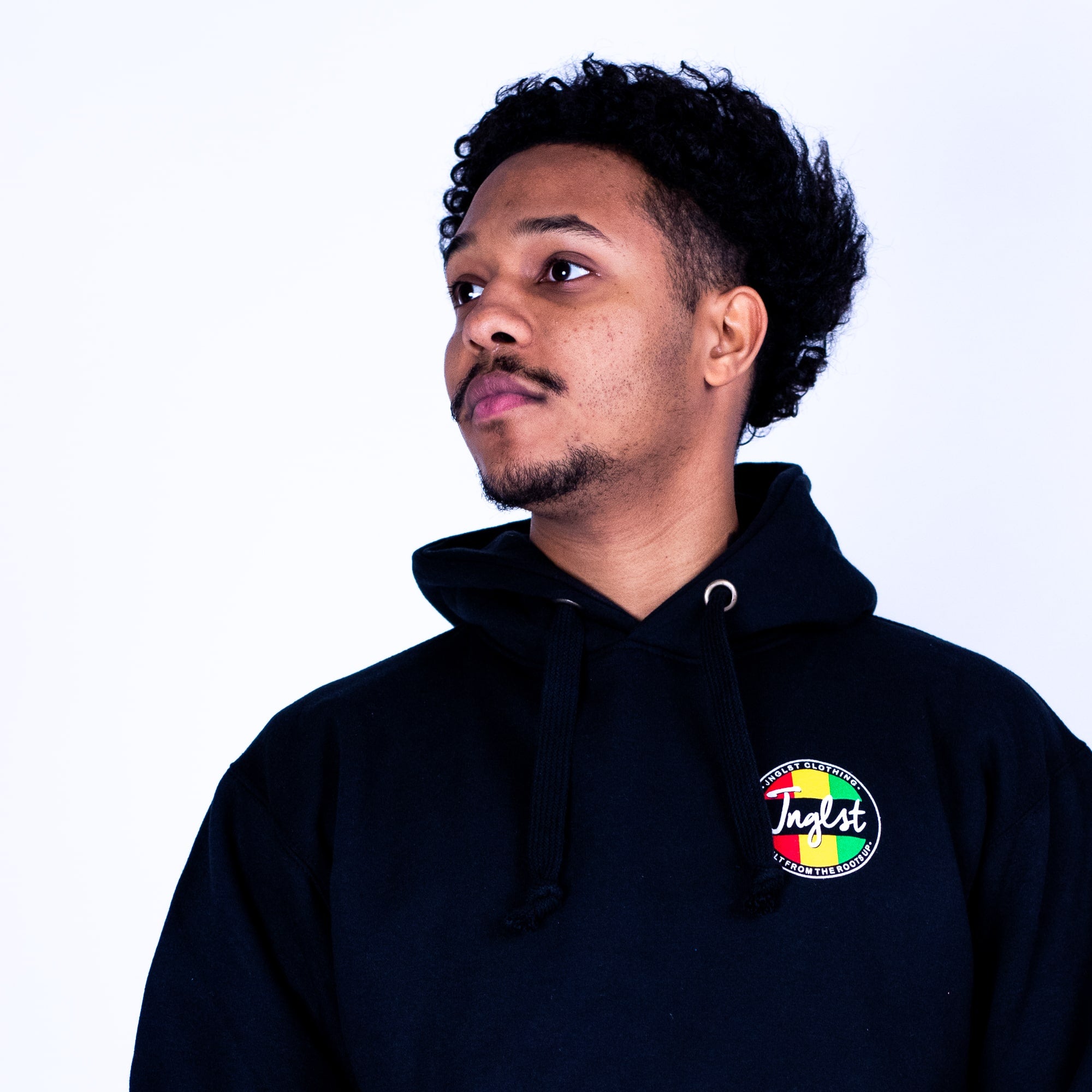 Person wearing a black hoodie with a colorful logo on a white background