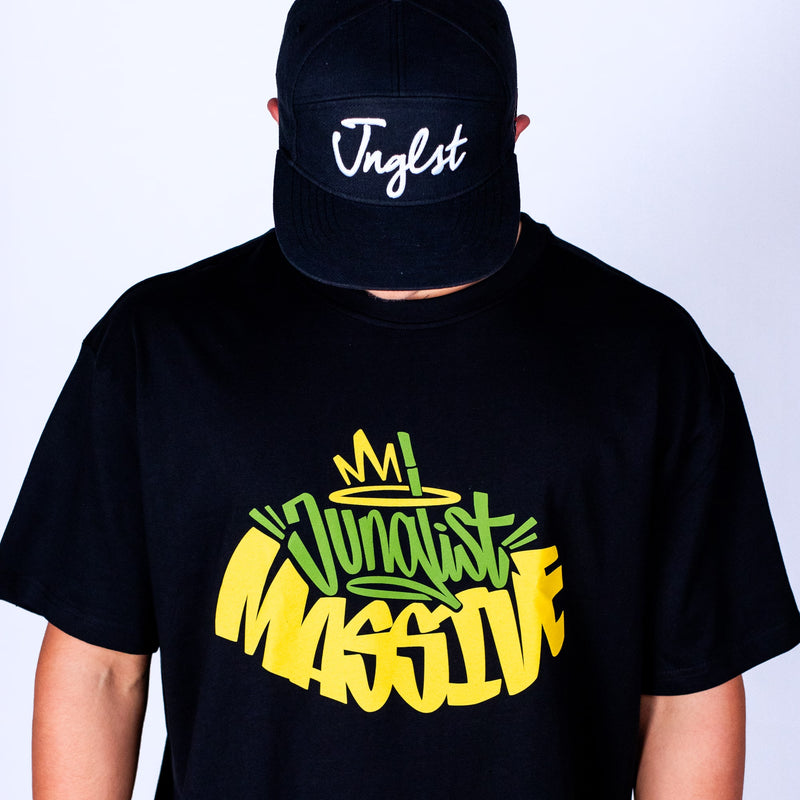 Person wearing a black t-shirt with colorful text and a black cap with 'Jnglst' on a white background