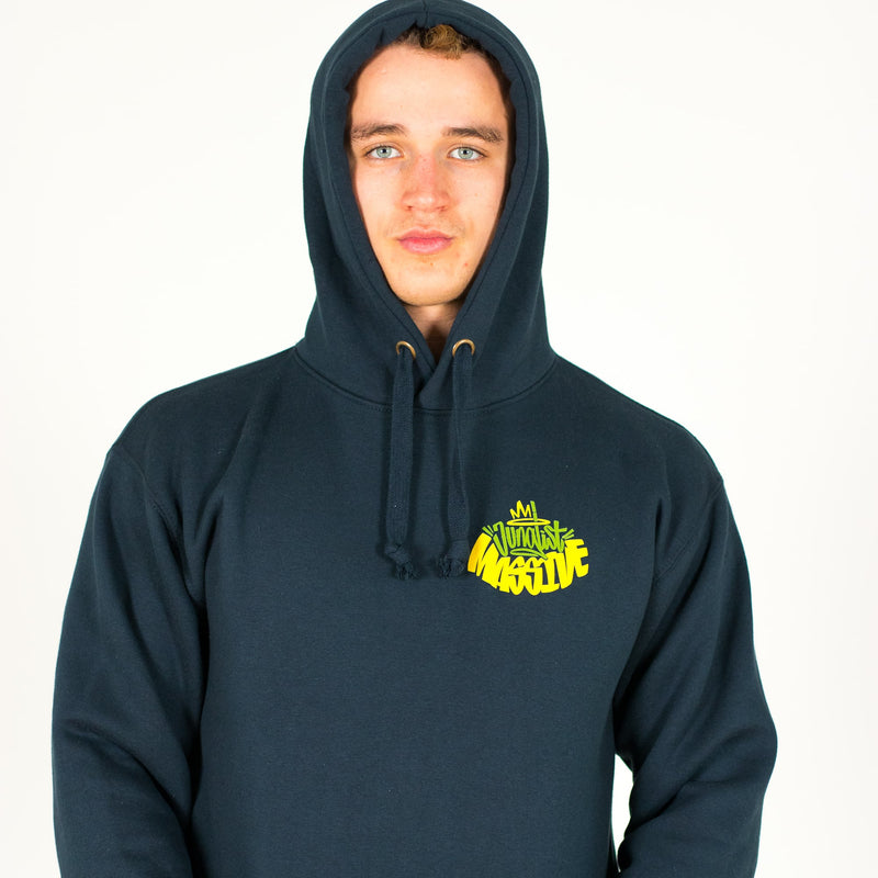 Person wearing a navy Junglist Massive hoodie with a yellow logo on a white background