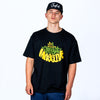 Person wearing a black oversized Junglist t-shirt with colorful text and a black cap on a white background