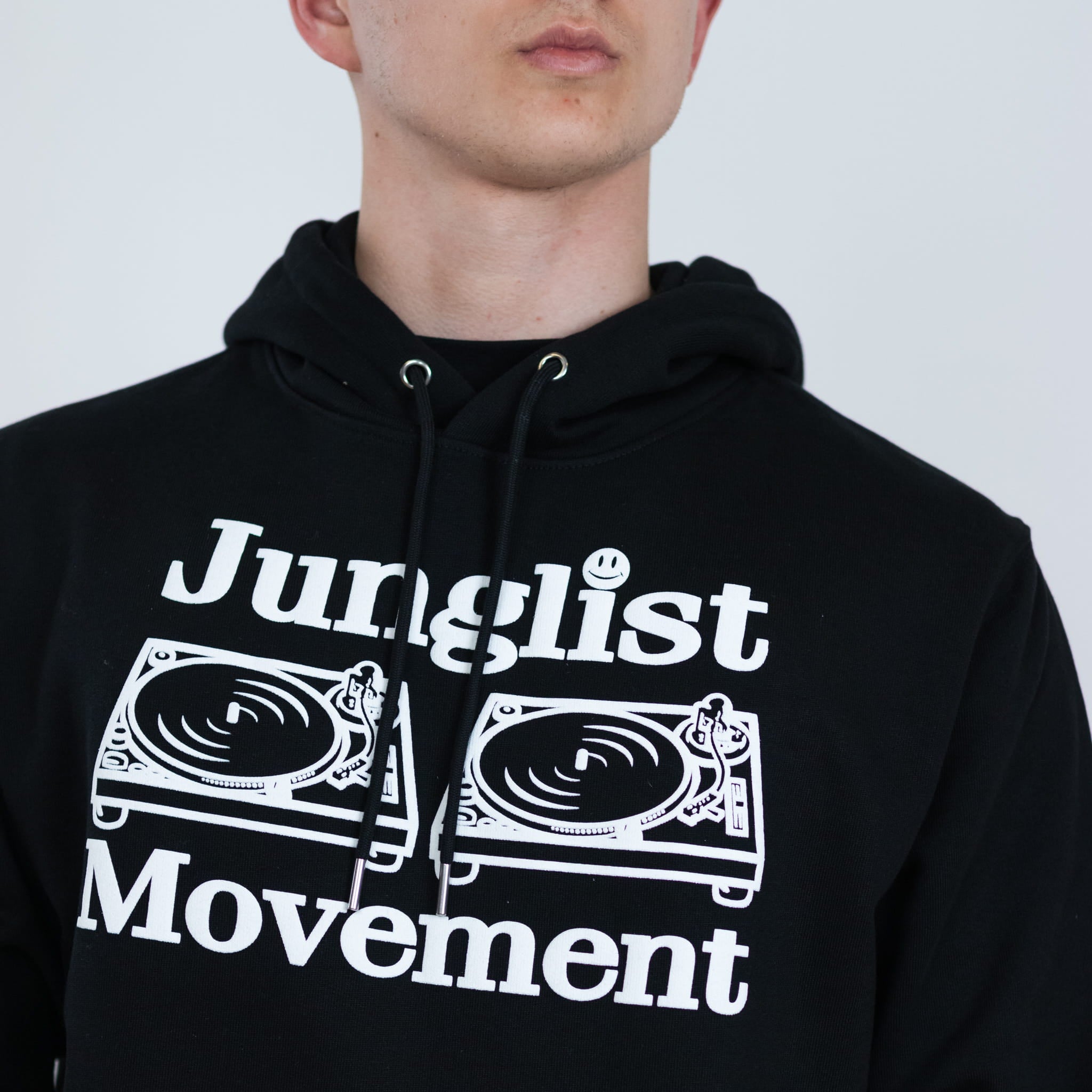Person wearing a black hoodie with 'Junglist Movement' text and graphics.