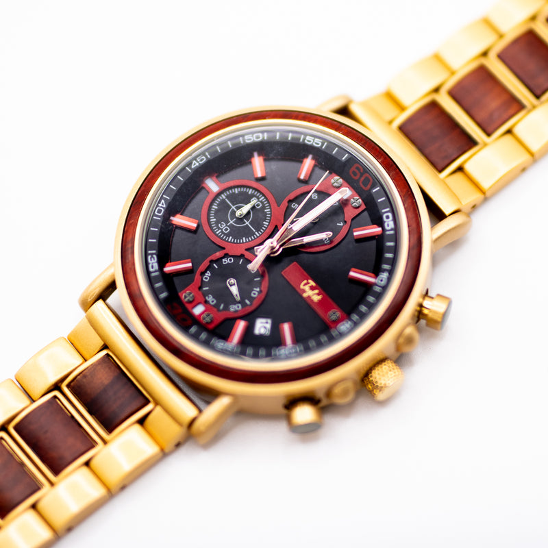 Bronze watch with a red and black face on a white background