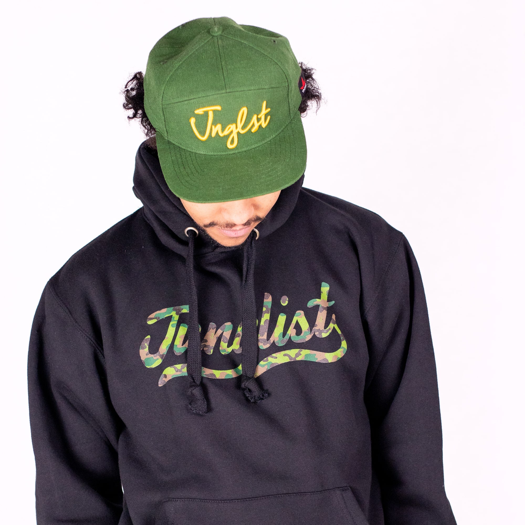 Person wearing a black hoodie and green cap with 'Jungleist' branding on a white background