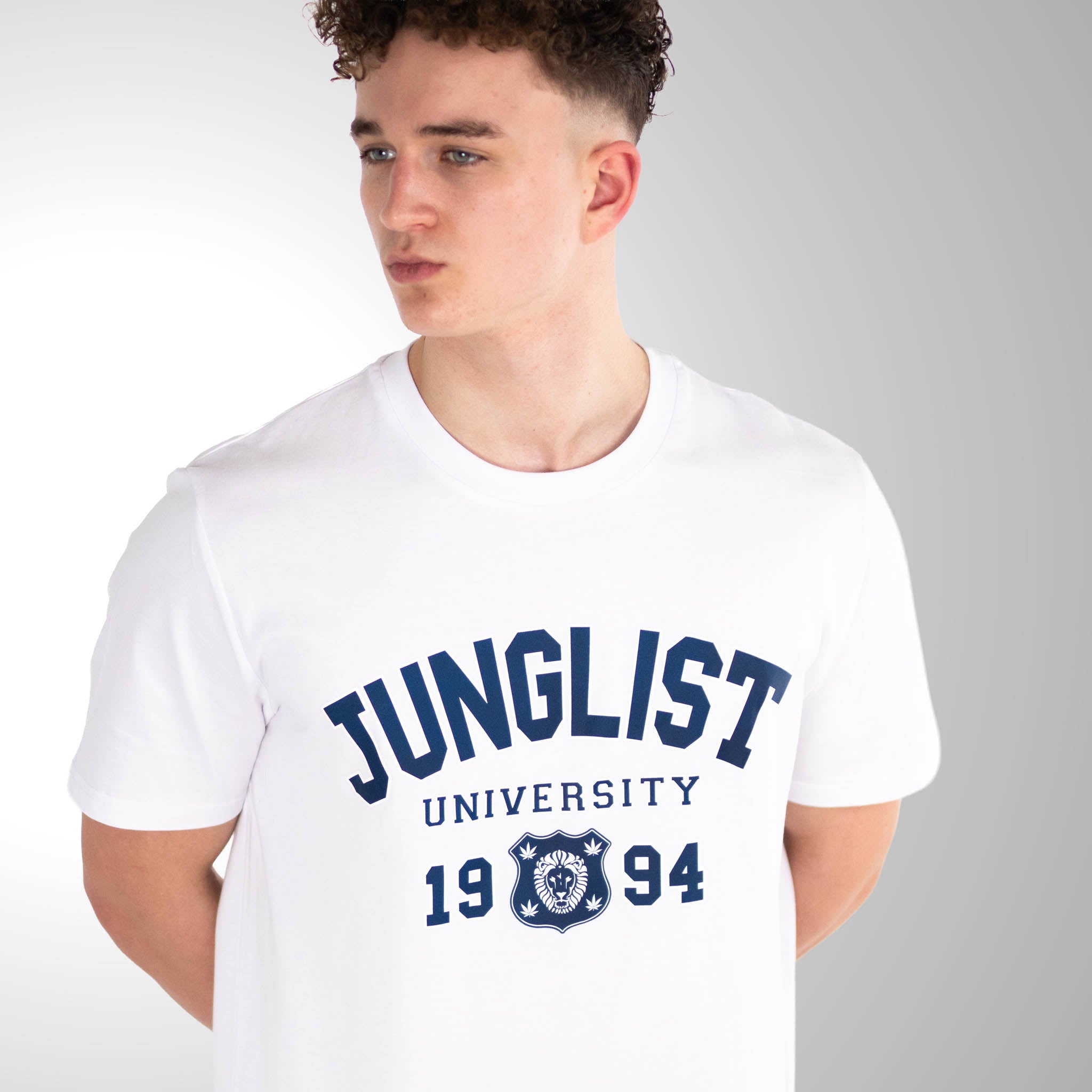 Person wearing a white t-shirt with 'Junglist University 1994' text and logo.