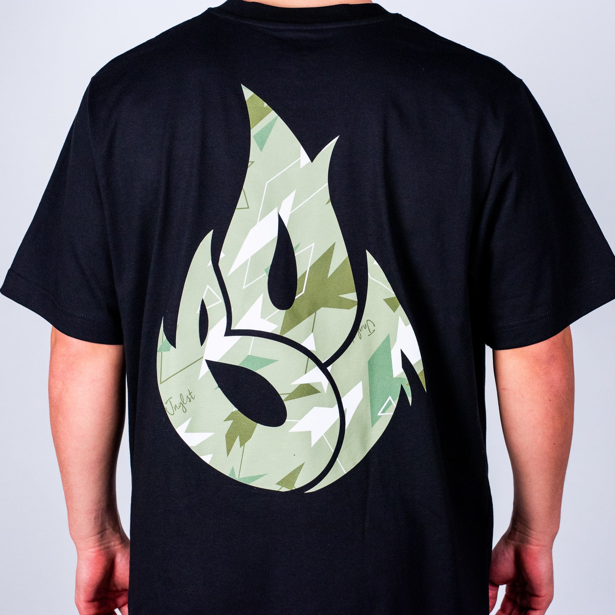 Black  Born Outta Fire t-shirt with a green and white design on the back against a plain background
