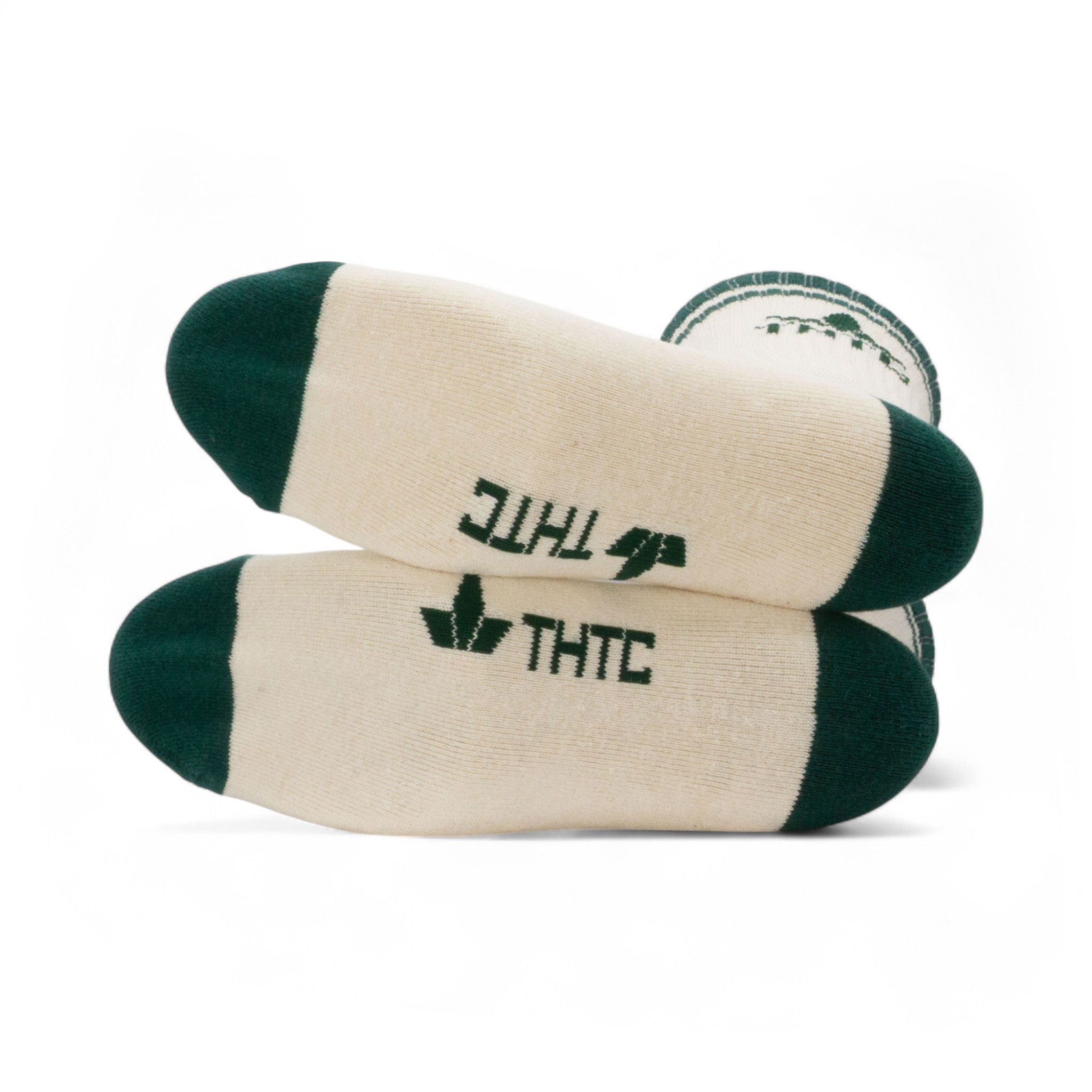 Pair of beige socks with green accents and 'THC' branding on a white background