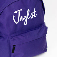 Purple backpack with 'Jnglst' text on a white background