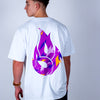 Person wearing a white Junglist t-shirt with a colorful logo on the back against a plain background