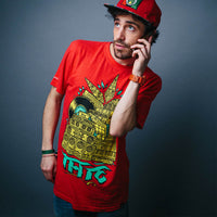 Man wearing a red t-shirt with a colorful graphic design on a gray background