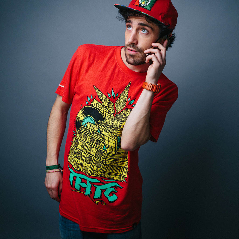 Man wearing a red t-shirt with a colorful graphic design on a gray background